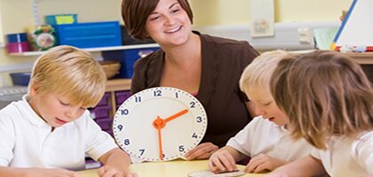 teacher with small group and clock